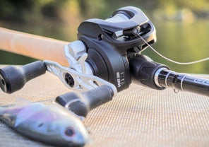 A Bates Goat SWM 200 sitting next to a swimbait on a vinyl boat dock.