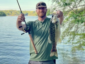 A member of the TW staff displays a health Lake Lanier spotted bass while fishing from shore.