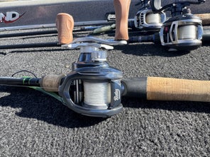 Shot of the Bates Fishing Co. Salty Hundo 100 Casting Reel sitting on the deck of a bass boat