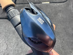 Side shot of the bates fishing co salty hundo 100 casting reel in hand. 