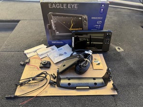 The Eagle Eye 9 LIve Fishfinder with all of the included pieces displayed on the front deck of a bass boat
