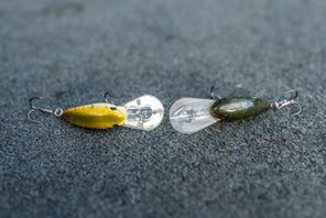 Top view of two Strike King Gravel Dawg crankbaits laying on a bass boat deck with their bills facing each other.