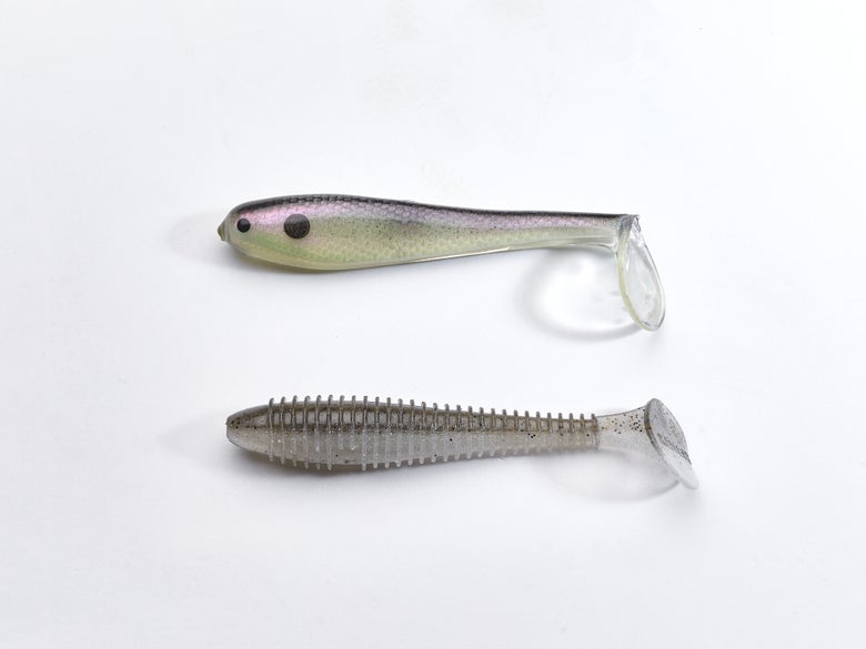 A hollow and solid-bodied paddle-tail swimbait next to each other