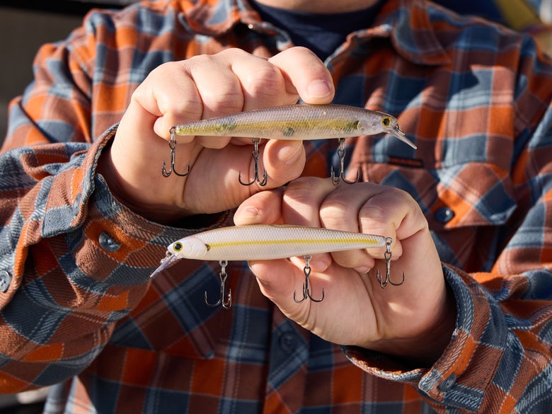 Two Lucky Craft Slender Pointer 112MR Jerkbaits being held up in front of the camera