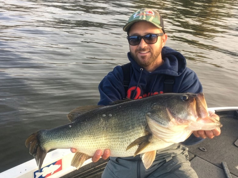 Joey proudly displaying an 11lb bass tricked into eating a TN70 on clearlake