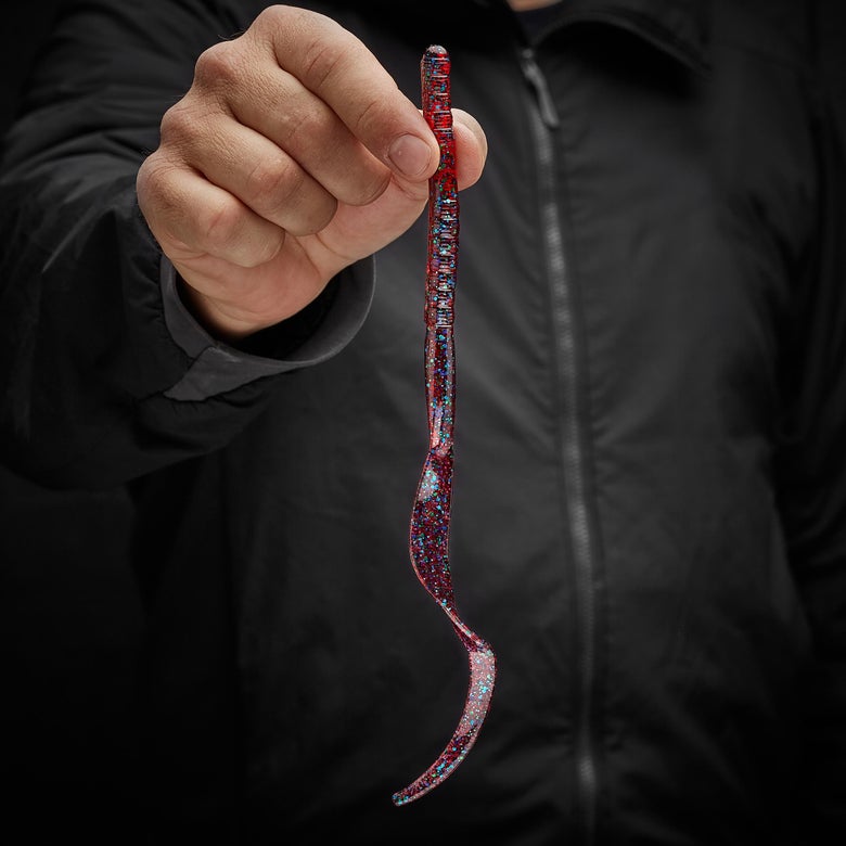 Angler holding a curly tail worm