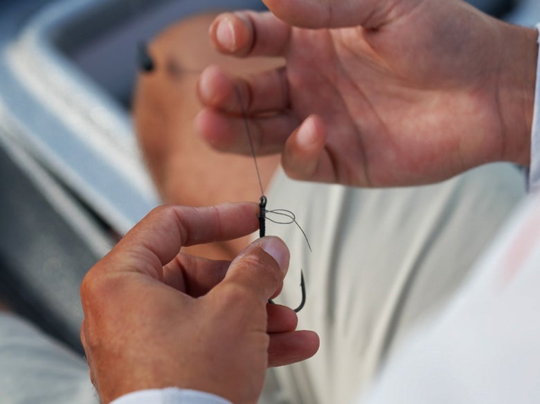 angler tying knot to a flipping hook
