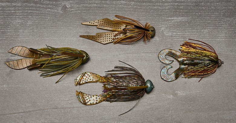 Four different jigs each with a different plastic trailer attached.