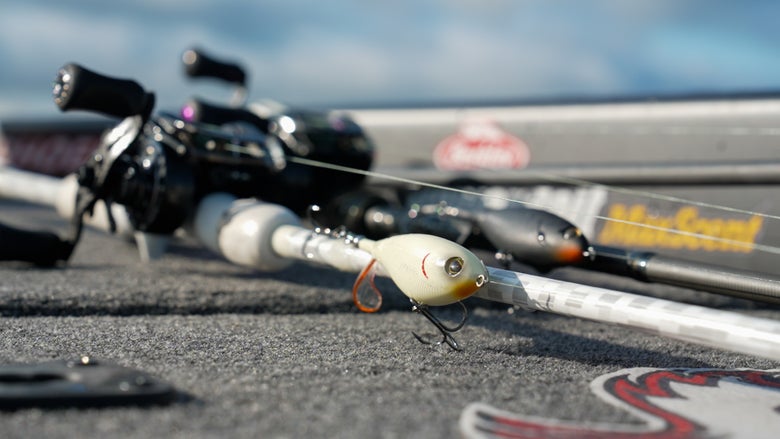 Topwater Ploppers on rigged rods laying on boat deck