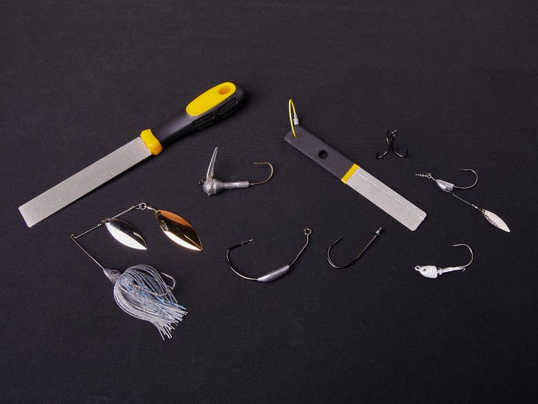 Hook files, various hooks and jig heads, and a spinnerbait sitting on a black background