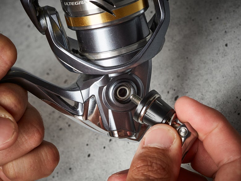Handle being removed from a spinning reel