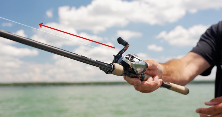 Angler holding a casting rod and reel while on the water