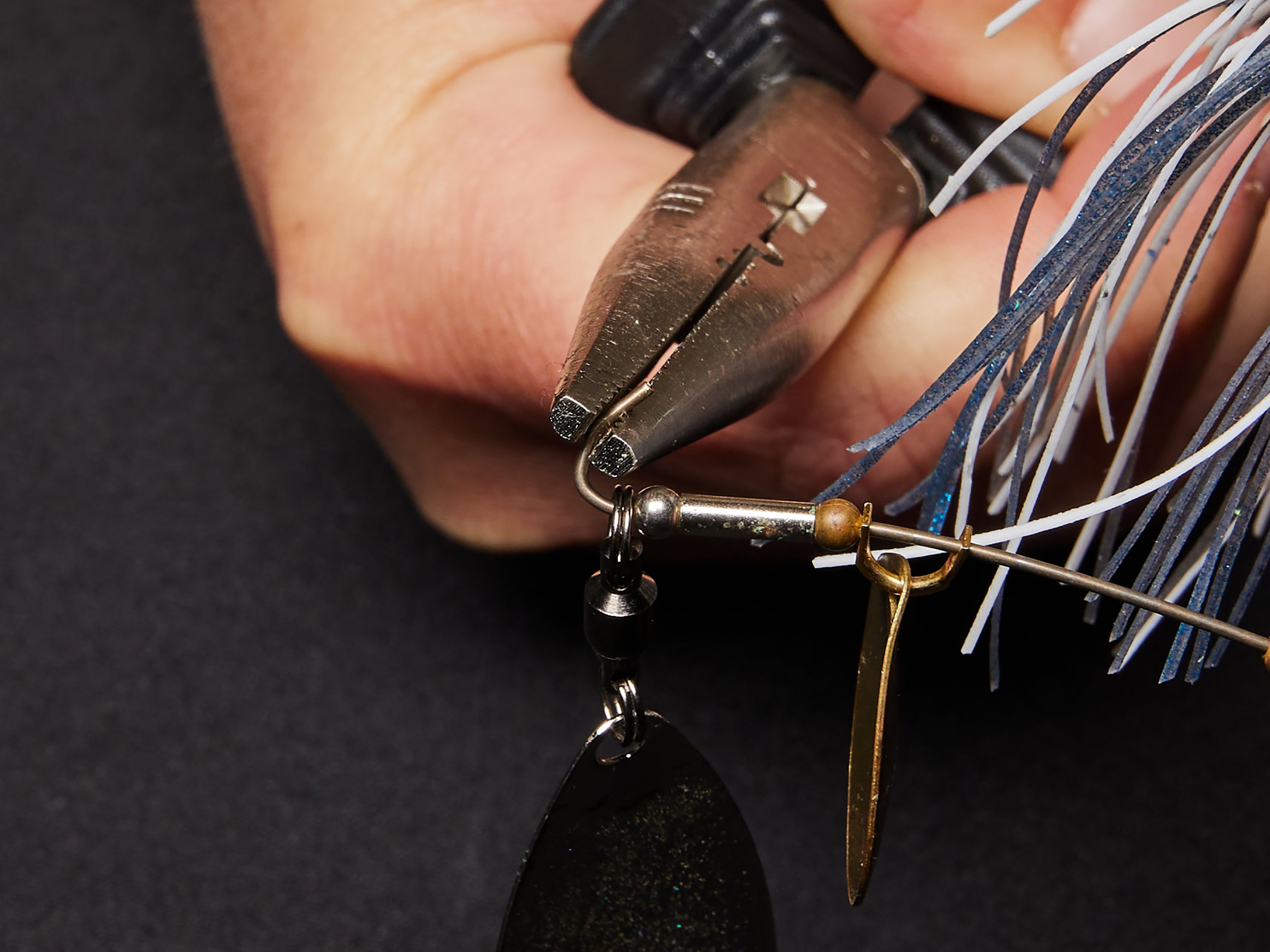 Opening the bend on the end of a spinnerbait arm.