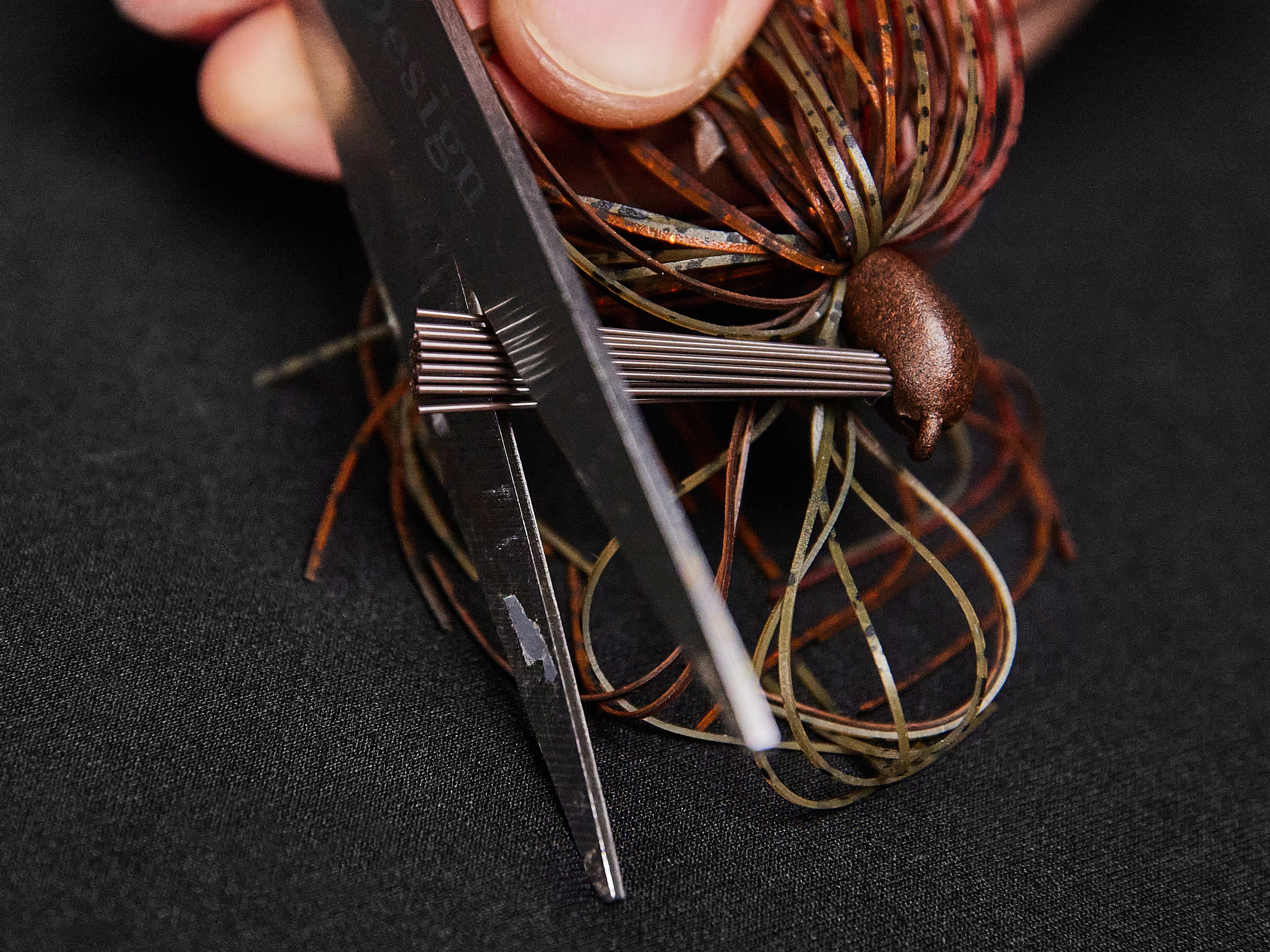 Trimming a fiber weedguard with scissors.
