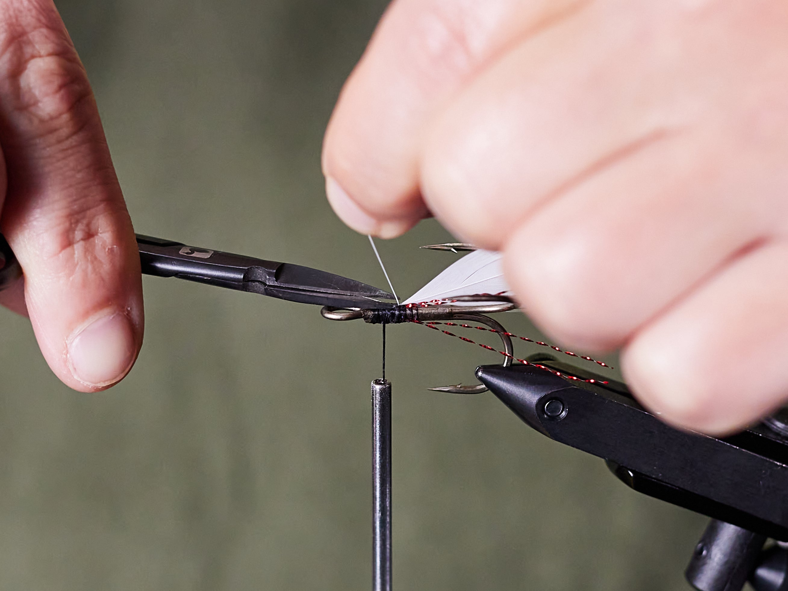 trimming tag end of feather after tying