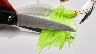 trimming the skirt of a spinnerbait