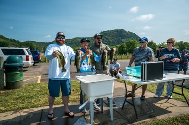 bass anglers at weigh-in of fishing tournament